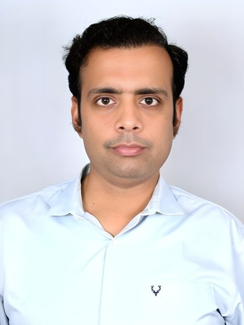 Dr. Nimish Kumar Singh in a light blue shirt
