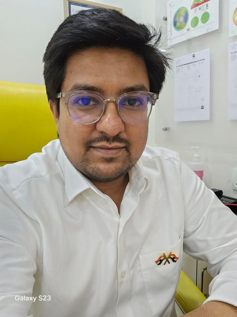Dr. Ritwick Rohin in a white shirt and glasses