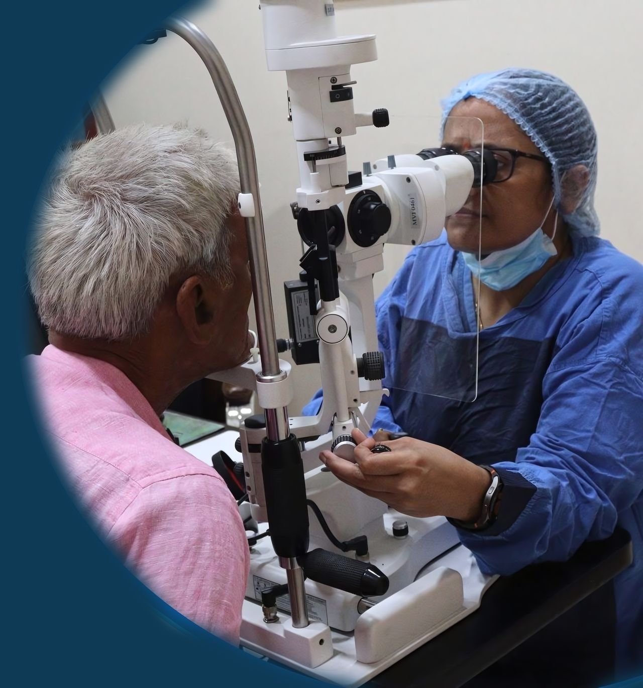 A Sarvdrishti eye doctor examining an older patient at the slit lamp